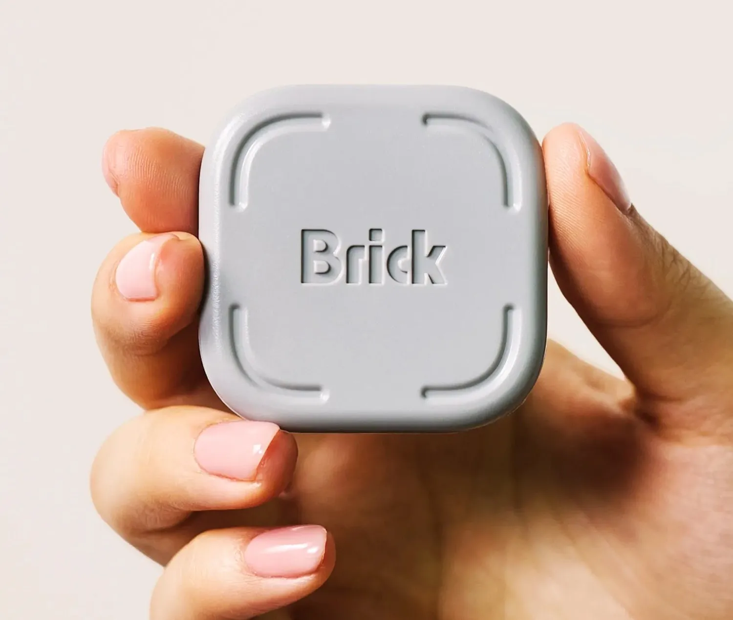 Brick white NFC device plugged into a wall outlet