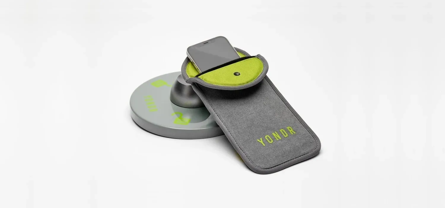 Yondr grey fabric phone pouch with magnetic locking mechanism at the top